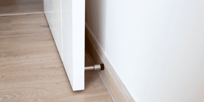 A door stopper fitted to the skirting board behind a door