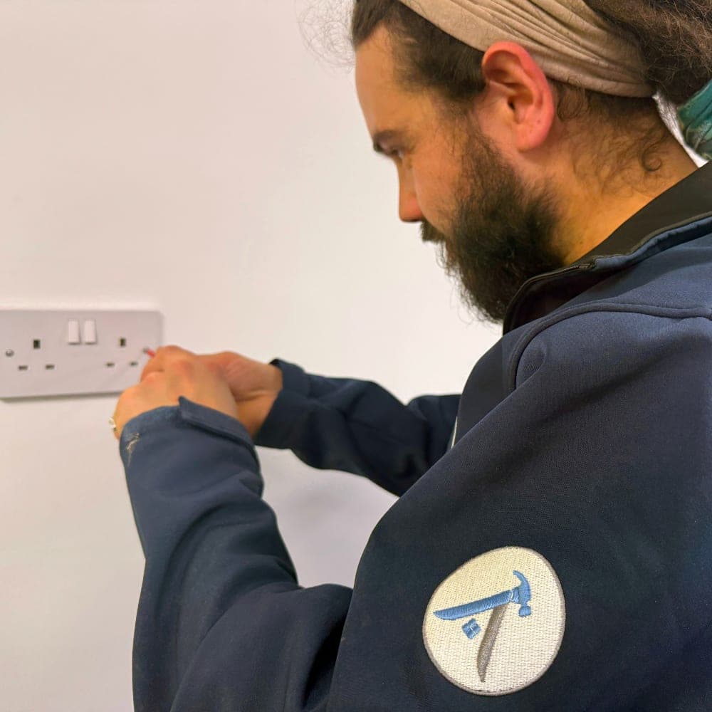 A tradesman checking a double wall socket
